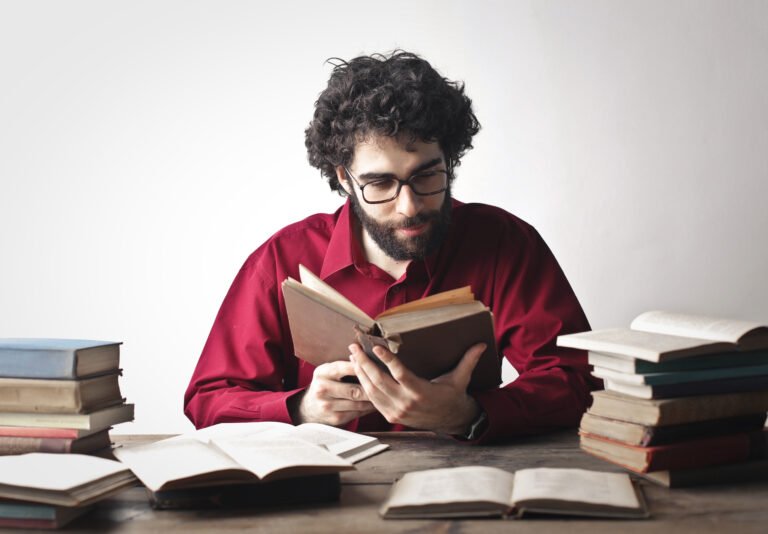portrait of young man while studying on books
